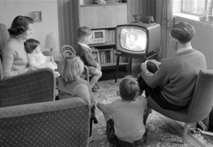 Family from the 50's in front of their TV.