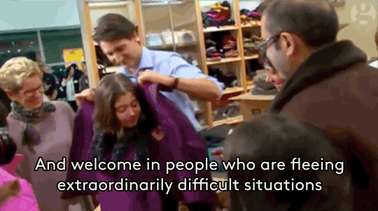 Canadian Prime MInister Justin Trudeau helps a young refugee adjust to the cold Canadian climate.