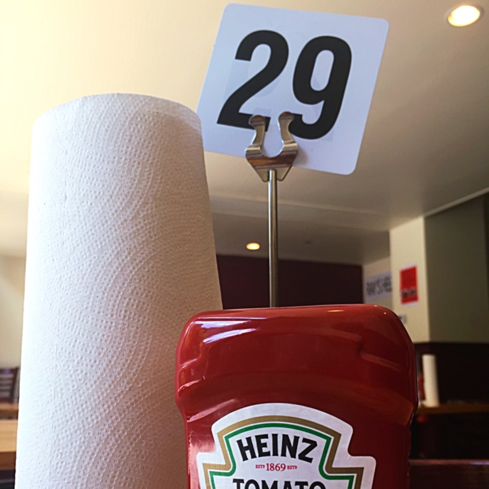 Generic ketchup and roll of papertowels at the most nondescript restaurant.