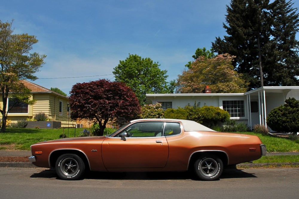 Plymouth Satellite Sebring parked on an idyllic suburban street.