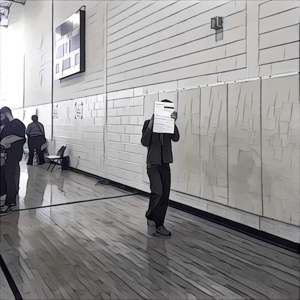 Hiding behind his ballot in the gym. 