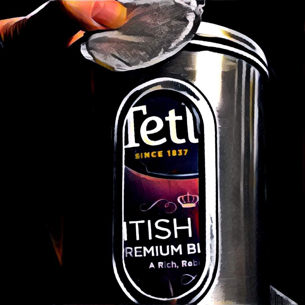 A tea tin, filled with bags of tea. English breakfast.