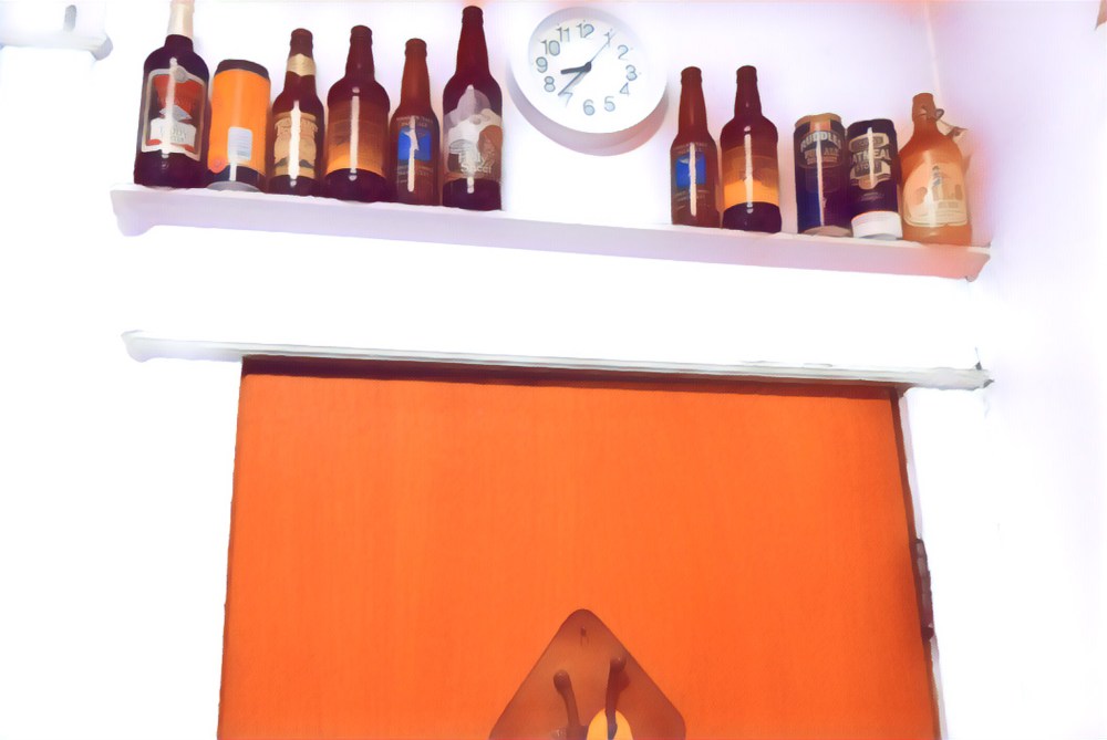 The backdoor, out of the kitchen topped with an odd assortment of empty beer bottles and the kitchen clock. 