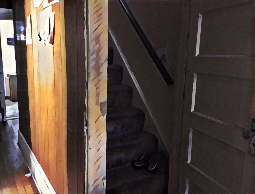 The staircase to the upstairs in the center hall. 