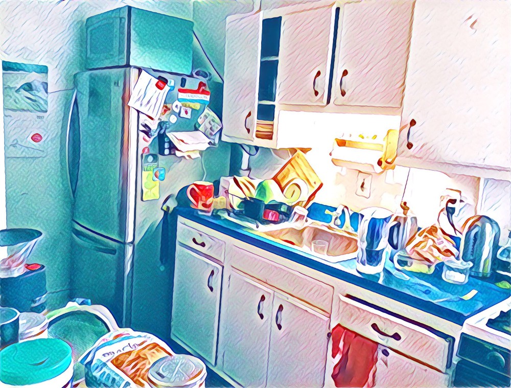 The current state kitchen from big stainless steel fridge to teeny counter to old sink to more teeny to stove. Also some raggedy cabinets. And no backsplash. 